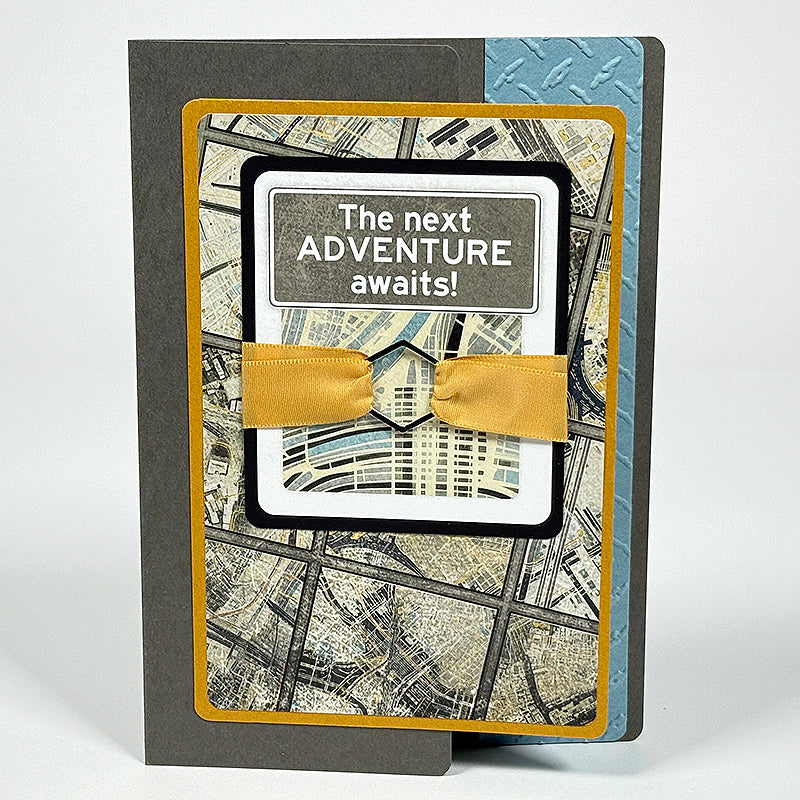 Greeting card with map design and 'The next ADVENTURE awaits!' text on a white background